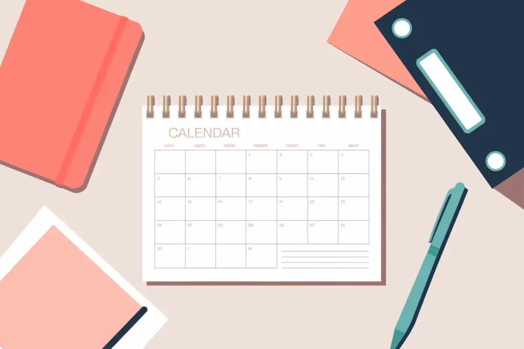 open calendar on work table with teal pen and coral notepads